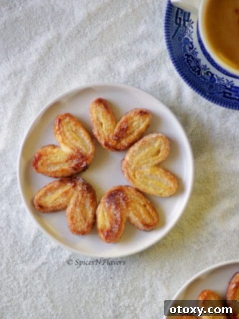 20 Effortless Puff Pastry Delights 15 Crispy, heart-shaped Palmiers, dusted with sugar, showcasing their signature flaky layers.