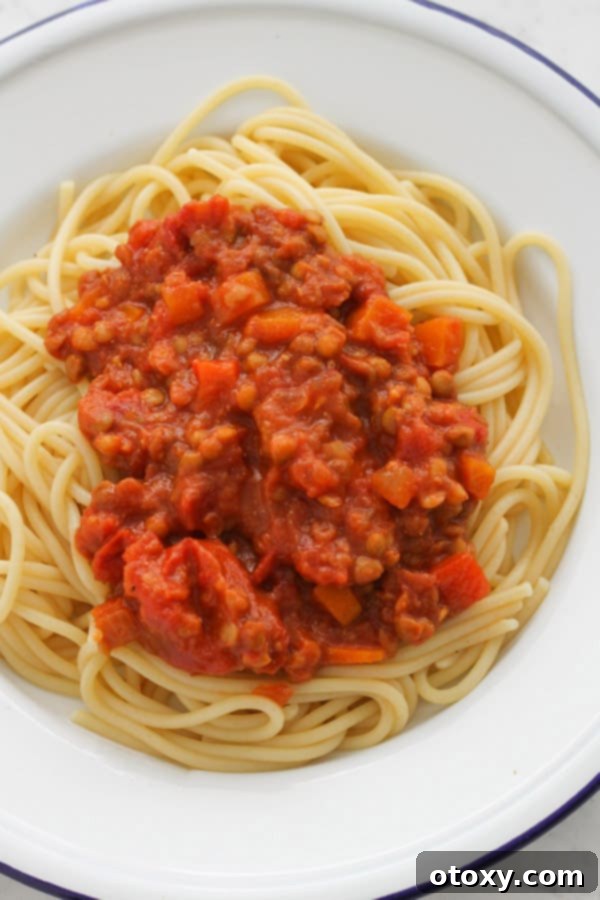 Plated vegetarian bolognese with spaghetti, ready to be enjoyed, showing a generous amount of sauce.