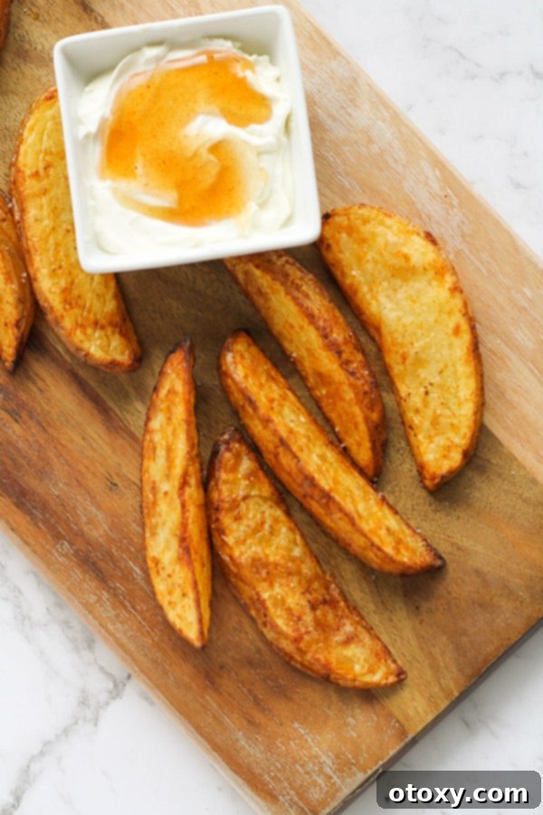 potato wedges on a wooden cutting board.