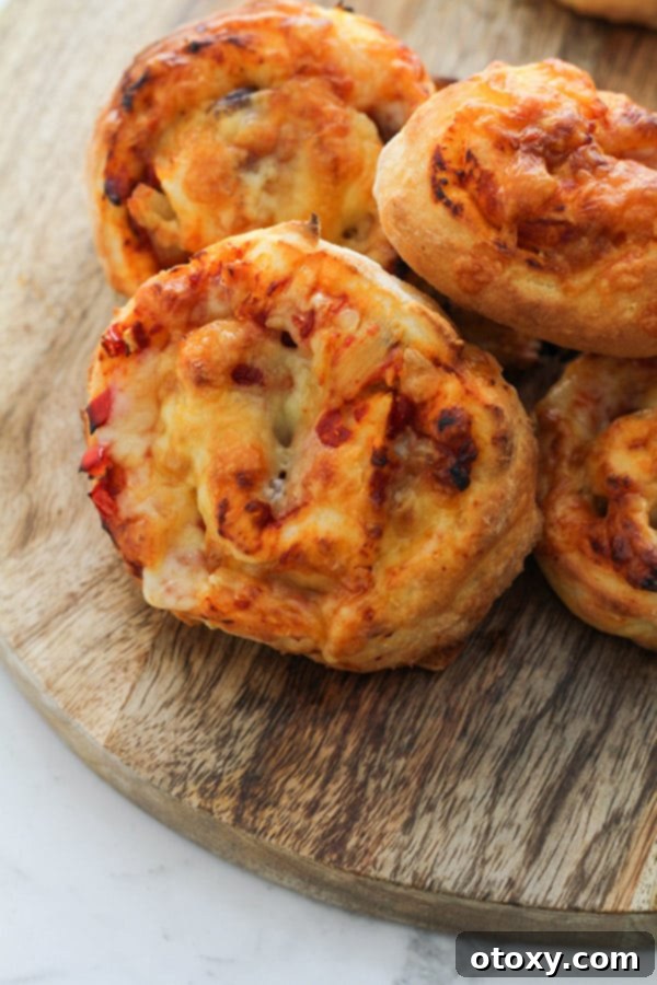 Delicious vegetarian pizza scrolls on a rustic wooden cutting board, ready to be served.