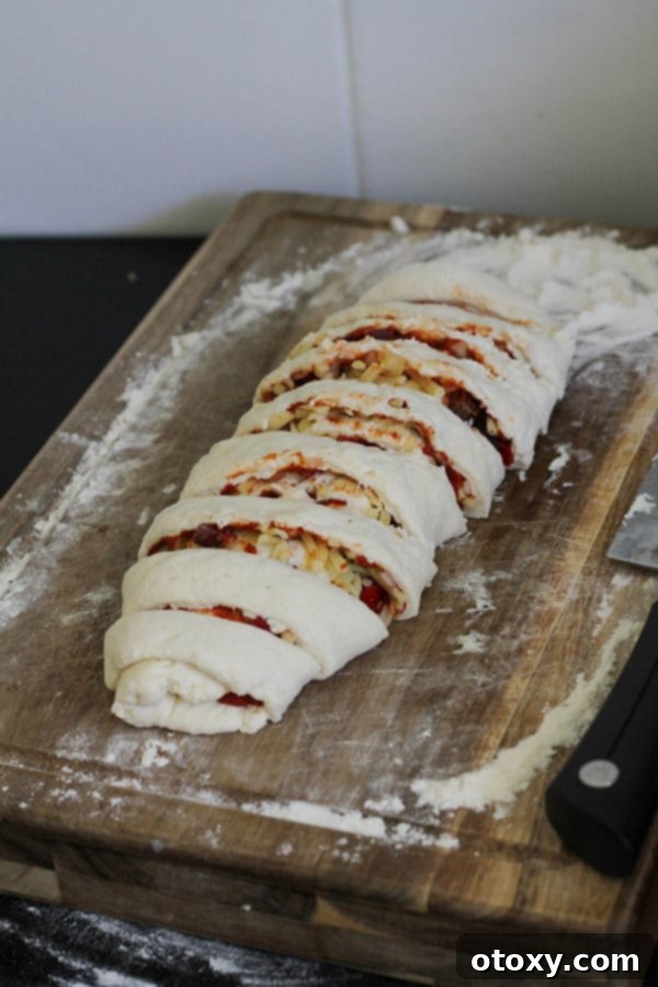 Rolled and cut pizza dough pieces arranged on a wooden board.