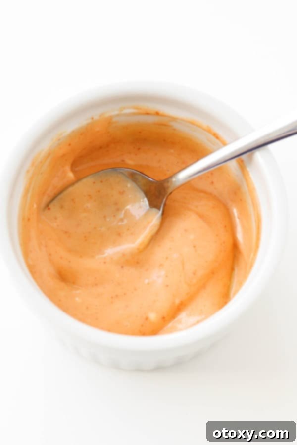 Flavor Burst Drizzle 2 A perfectly portioned bowl of homemade Bang Bang Sauce, ready for dipping.