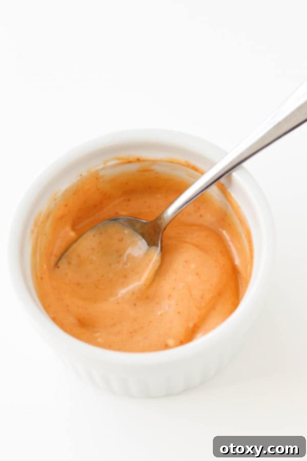 Flavor Burst Drizzle 5 A generous serving of creamy Bang Bang Sauce in a pristine white bowl.