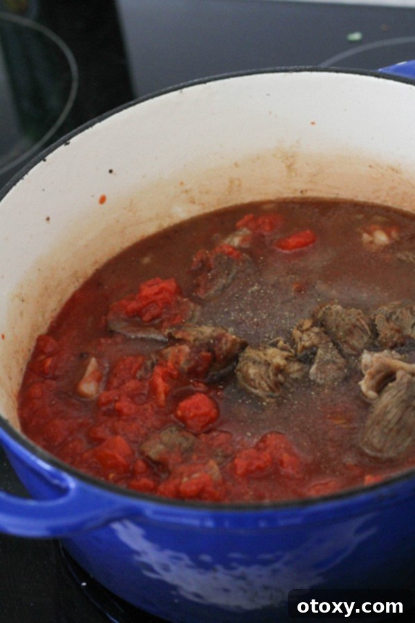 beef, tomatoes, stock, garlic, and Worcestershire sauce combined in a dutch oven.