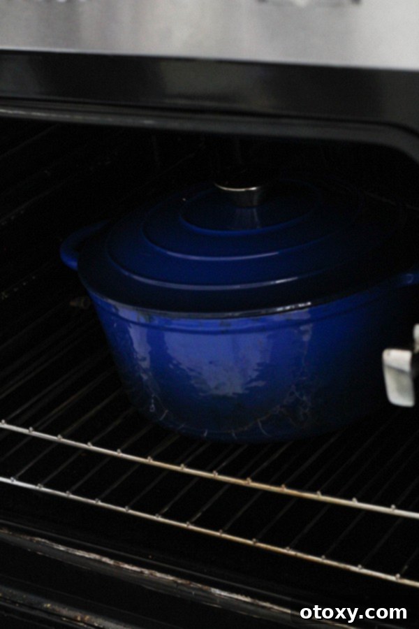 a lidded dutch oven placed inside a preheated oven for braising.