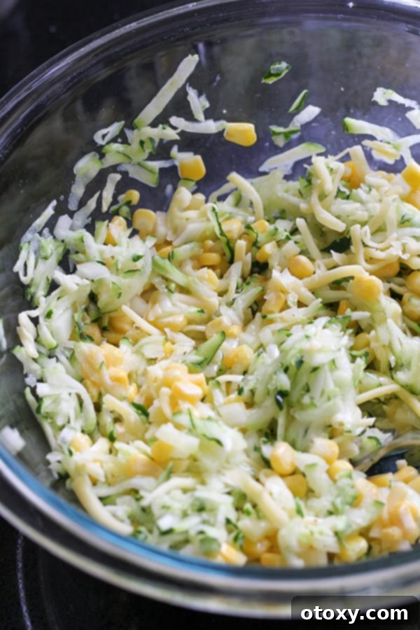 fritter ingredients in a glass mixing bowl.