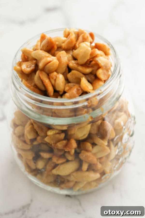 Easy Honey Roasted Peanuts in Your Oven or Air Fryer 2 A glass jar filled with golden honey roasted peanuts, invitingly delicious and ready to be enjoyed.
