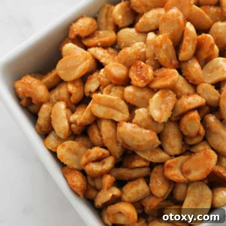 Easy Honey Roasted Peanuts in Your Oven or Air Fryer 13 A bowl of freshly made honey roasted peanuts, glistening with a sweet and savory glaze.
