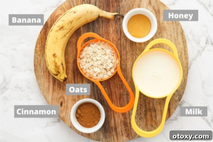 Golden Banana Breakfast Bowl 4 A rustic wooden board showcasing the wholesome ingredients for banana porridge: ripe bananas, honey, rolled oats, milk, and a shaker of cinnamon.