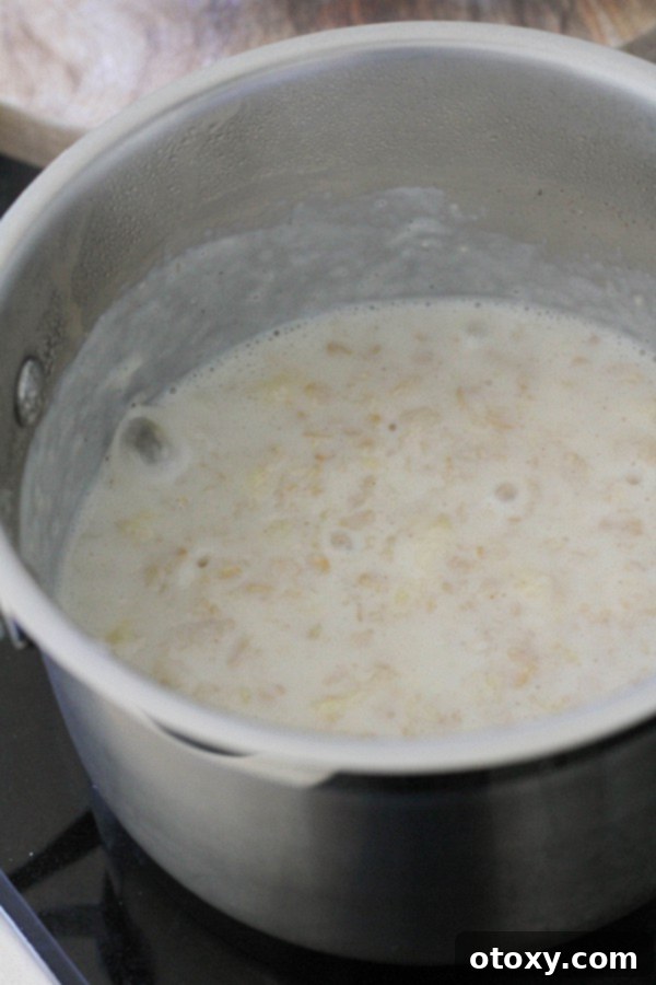 Golden Banana Breakfast Bowl 6 A saucepan on the stove with thickened banana porridge, indicating it's almost ready to serve.
