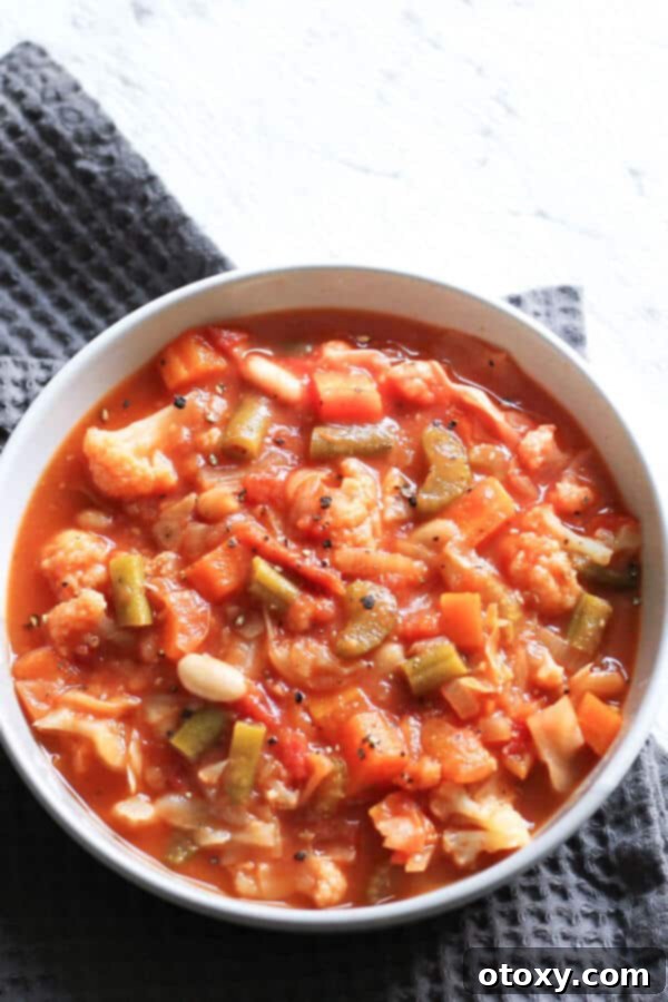 cannellini bean soup in a white bowl on a grey napkin