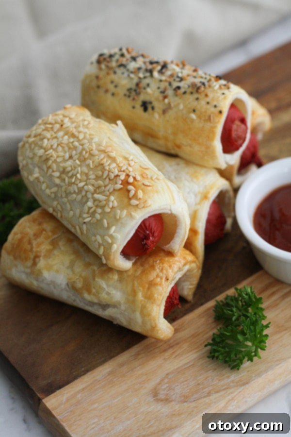 Stacked golden-brown puffy dogs on a rustic wooden serving board, ready to be enjoyed.