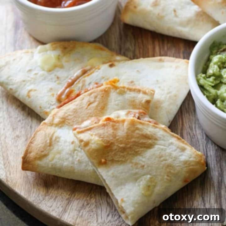 quesadilla quarters on a wooden board with avocado and salsa.