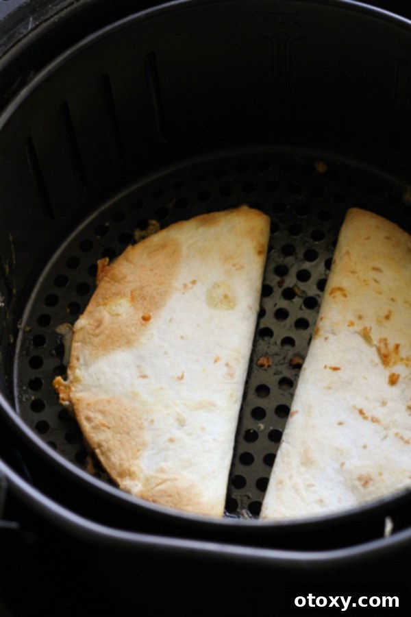quesadillas in an air fryer basket.