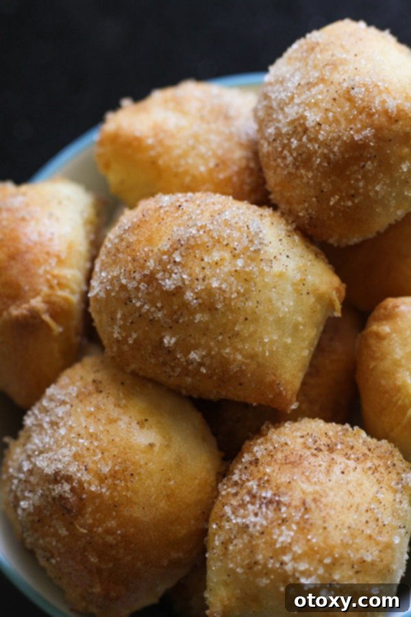 A bowl filled with warm, perfectly coated cinnamon sugar pretzel bites, ready for serving.