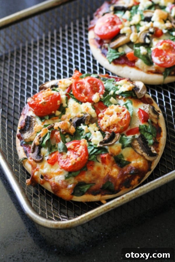 Mediterranean Greens and Feta Pizza 6 Two freshly baked pizzas cooling on a wire rack.