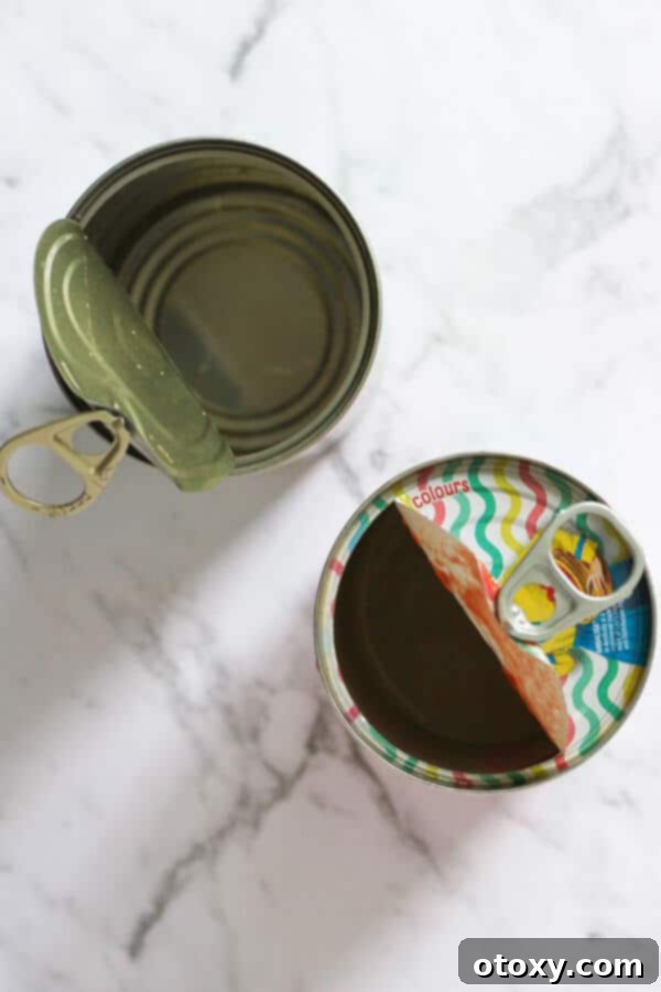 Golden Sweet Potato Lentil Bliss 4 Two empty cans of diced tomatoes, representing the convenient pantry ingredients used in the curry recipe.