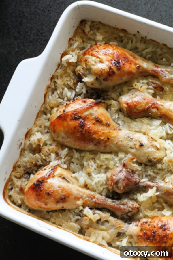 Golden-brown chicken drumsticks resting on a bed of fluffy lemon rice in a baking dish, ready to be served.