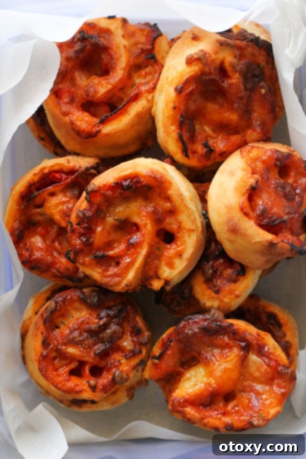 Air Fryer Pizza Pinwheels neatly packed in a clear lunchbox container, ready for transport.