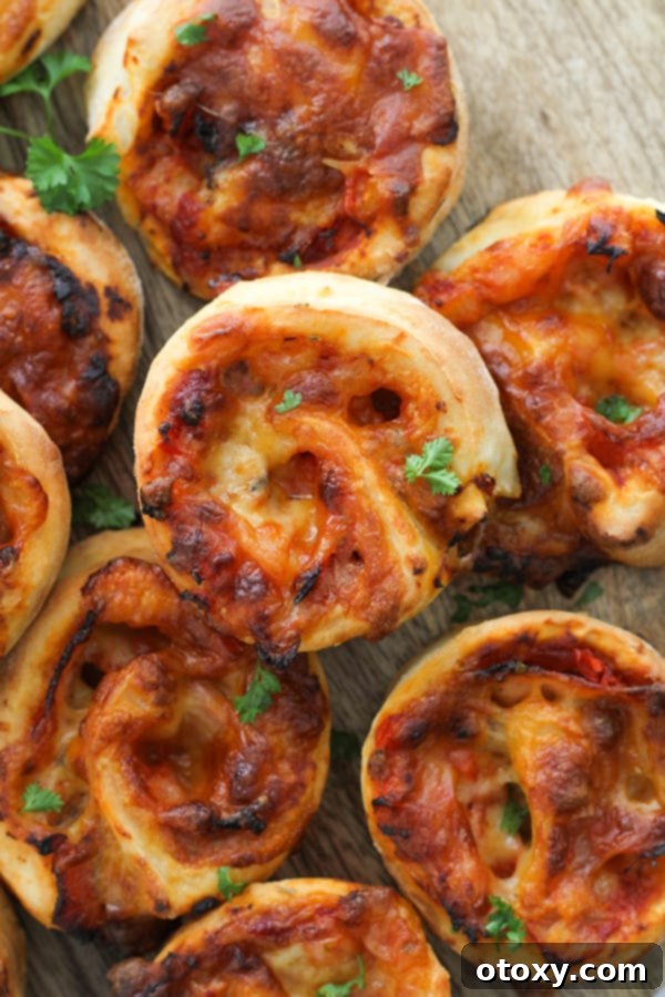 A rustic wooden board showcasing a beautiful arrangement of Air Fryer Pizza Pinwheels, perfect for serving.