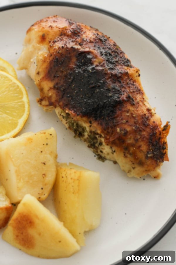 chicken and potatoes on a white plate.