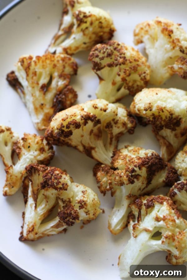 A beautifully plated serving of air-fried roasted cauliflower, garnished and ready to serve.