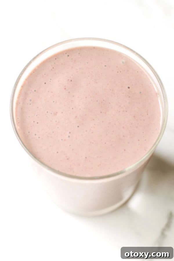 Tropical Burst Smoothie 5 mixed fruit smoothie in a small glass