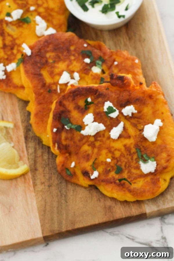 Golden Pumpkin Bites 3 pumpkin fritters laid on top of a wooden board.