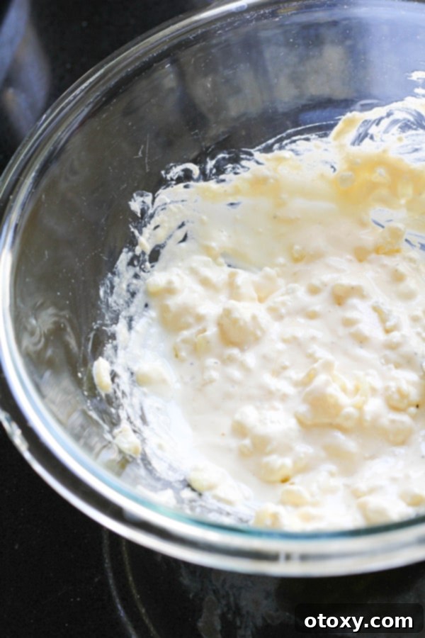 Golden Pumpkin Bites 7 feta, egg and onion mixed together in a glass bowl.