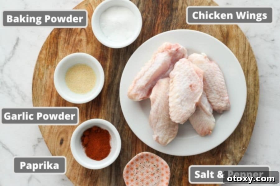 Air-Fried Wing Perfection 4 A wooden cutting board displays all the fresh ingredients needed for air fryer chicken wings, including a bowl of baking powder, garlic powder, paprika, and a stack of raw chicken wings.