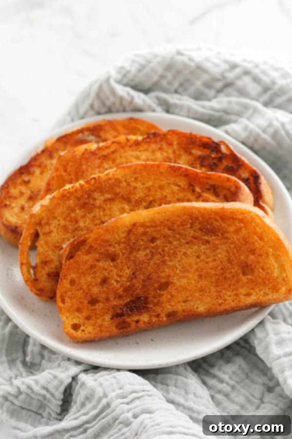 slices of cheese toast on a white plate.