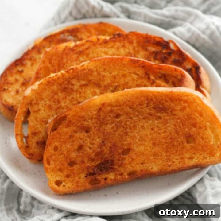 slices of cheese toast on a white plate.