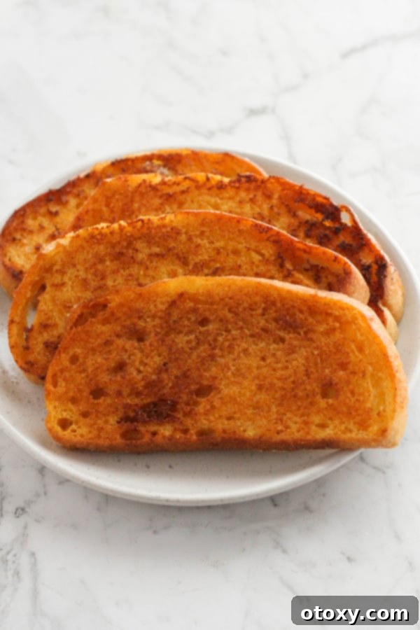 slices of cheese toast on a white plate.