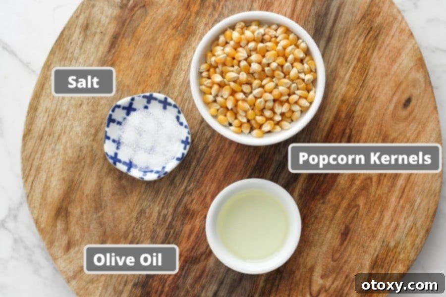 Stovetop popcorn ingredients laid out on a wooden board.
