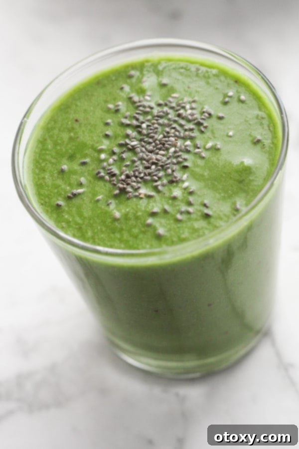 Vibrant Green Apple Smoothie 3 A refreshing green smoothie in a glass, with chia seeds sprinkled on top, ready to be enjoyed.
