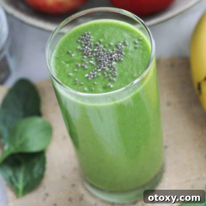 Vibrant Green Apple Smoothie 9 A tall glass of green smoothie, garnished with chia seeds, ready to be enjoyed.