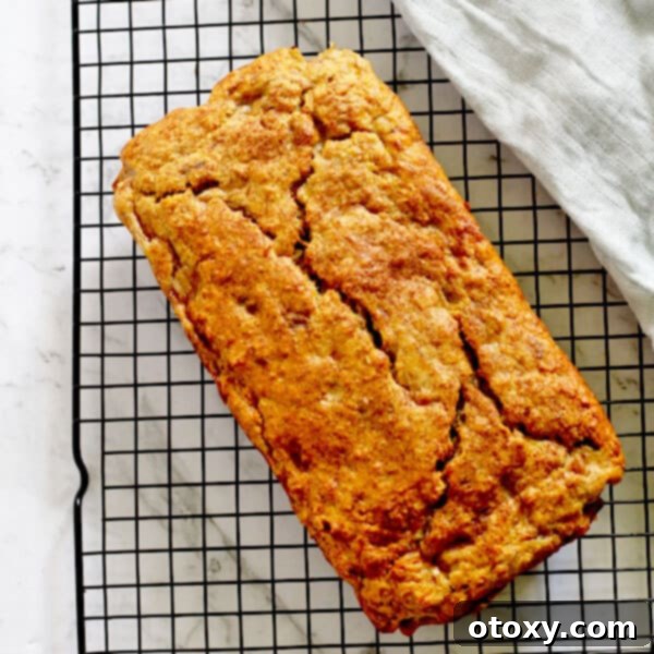 banana bread loaf resting on a cooling rack