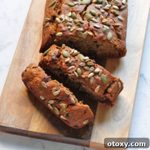 Wholesome Date Bread 3 Slices of healthy date loaf arranged artfully on a wooden cutting board, revealing the moist interior studded with dates.