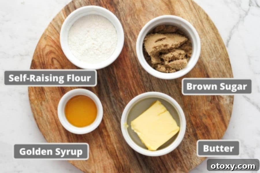 The four simple ingredients for golden syrup cookies laid out on a wooden board: butter, brown sugar, self-raising flour, and golden syrup.