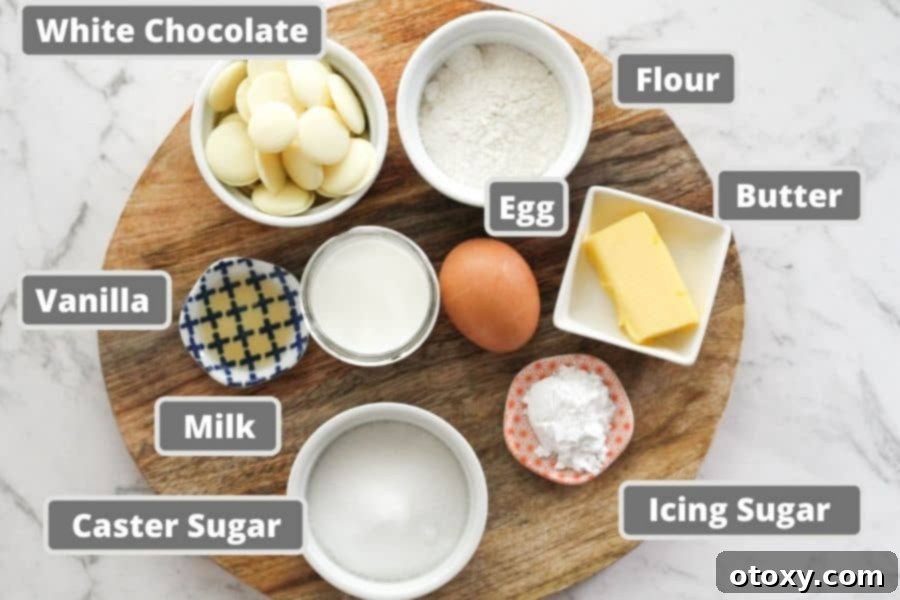 white chocolate cupcake ingredients on a wooden board including egg, white chocolate and butter.