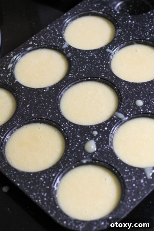 cupcake mixture spooned into muffin tray.