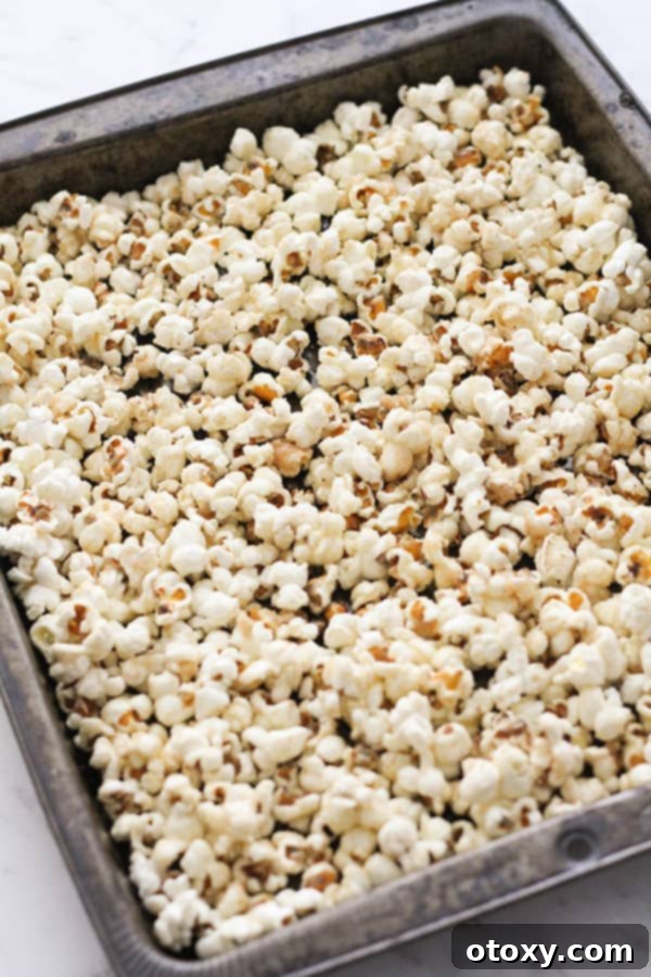 Baked cinnamon sugar popcorn cooling on a baking tray.