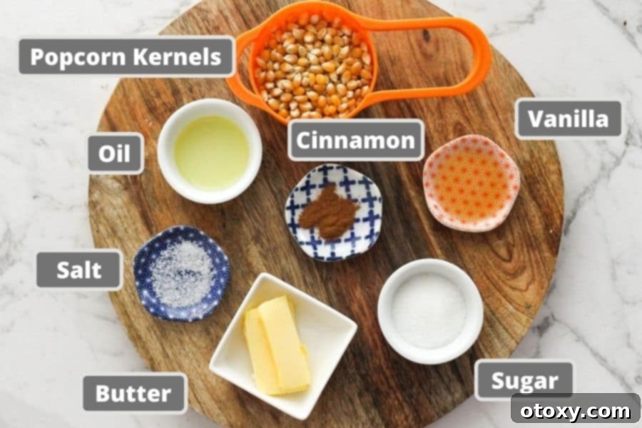 Ingredients for cinnamon sugar popcorn laid out on a wooden board: popcorn kernels, butter, sugar, and cinnamon.