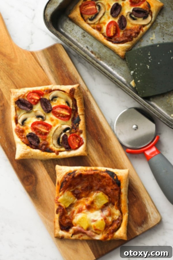 Puff pastry pizzas on a wooden board, showcasing their golden, flaky crust and vibrant toppings.