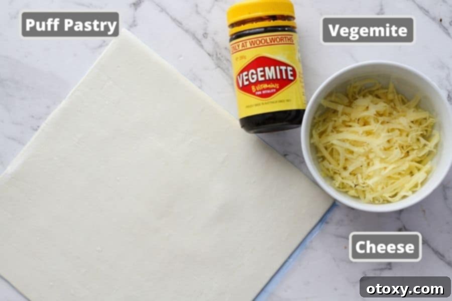 Easy Vegemite and Cheese Pinwheels Baked or Air Fried 4 A flat lay of the three essential ingredients: a block of cheese, a jar of Vegemite, and a pack of frozen puff pastry sheets.