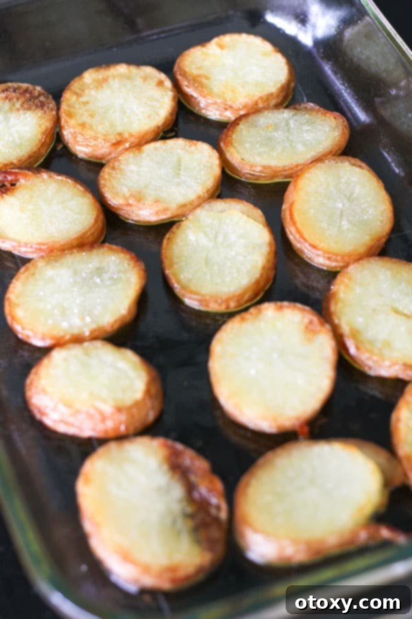 Crispy salt and vinegar potatoes perfectly golden brown, arranged in a baking dish after roasting.