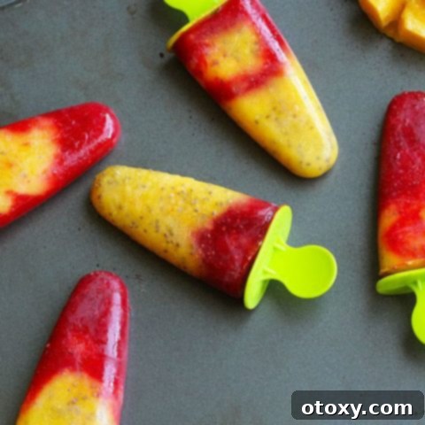 Beautifully layered Strawberry Mango Popsicles recipe image