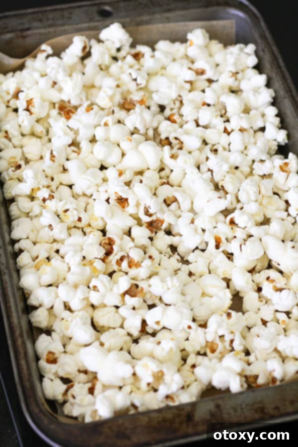 Decadent Chocolate Popcorn 7 popcorn on a baking tray.