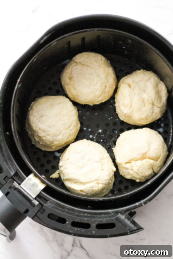 Golden Air Fryer Scones 8 Multiple scone rounds neatly placed within the air fryer basket, with adequate spacing between each, prepared and ready to be cooked to golden perfection.