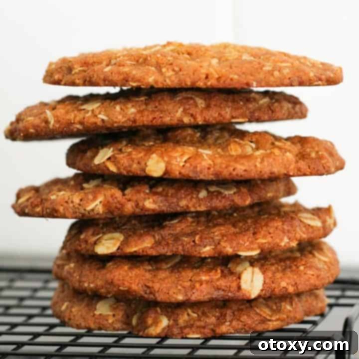 anzac biscuits stacked together on a wire rack.